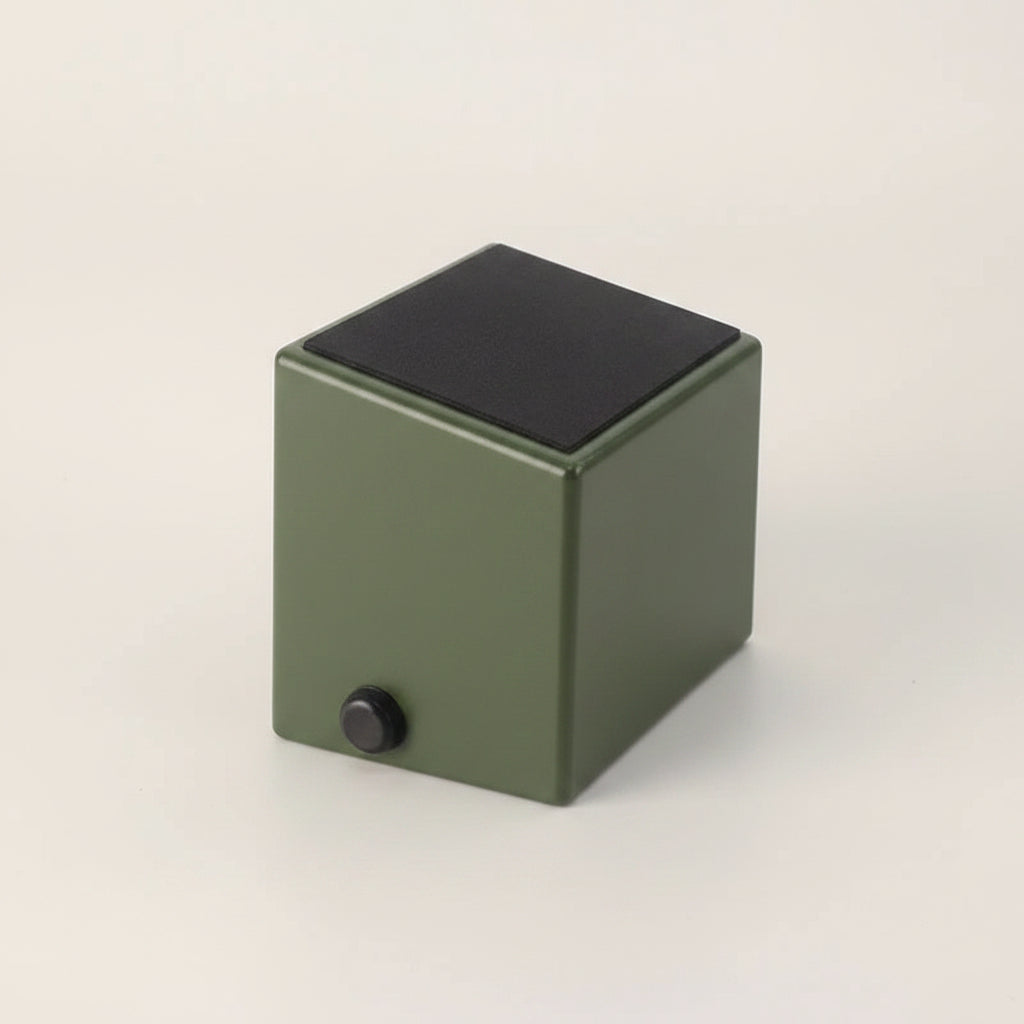 Green anti-slip and shock absorbing coffee knock box with a warm white background.