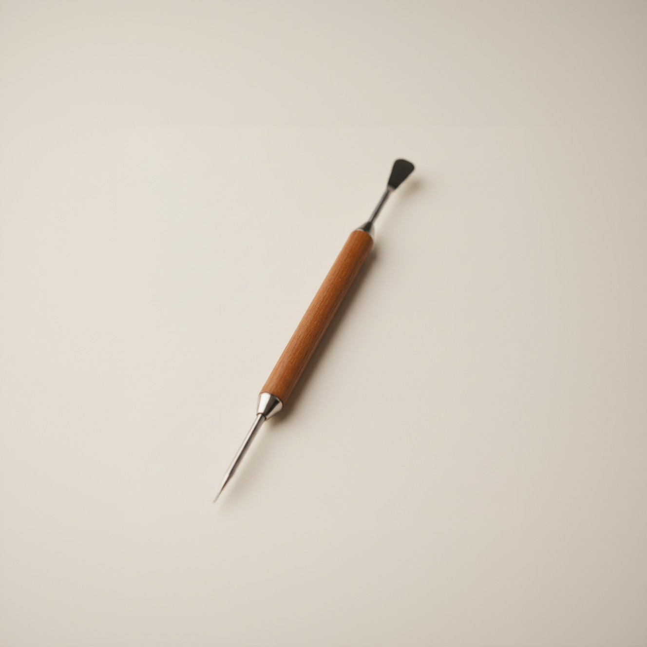 Wooden Latte Art Etching Pen with a pointed tip on a grey background
