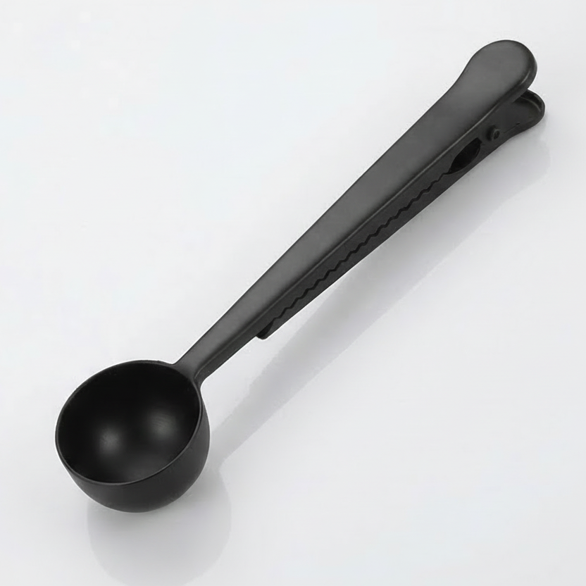 Black measuring spoon on a white background