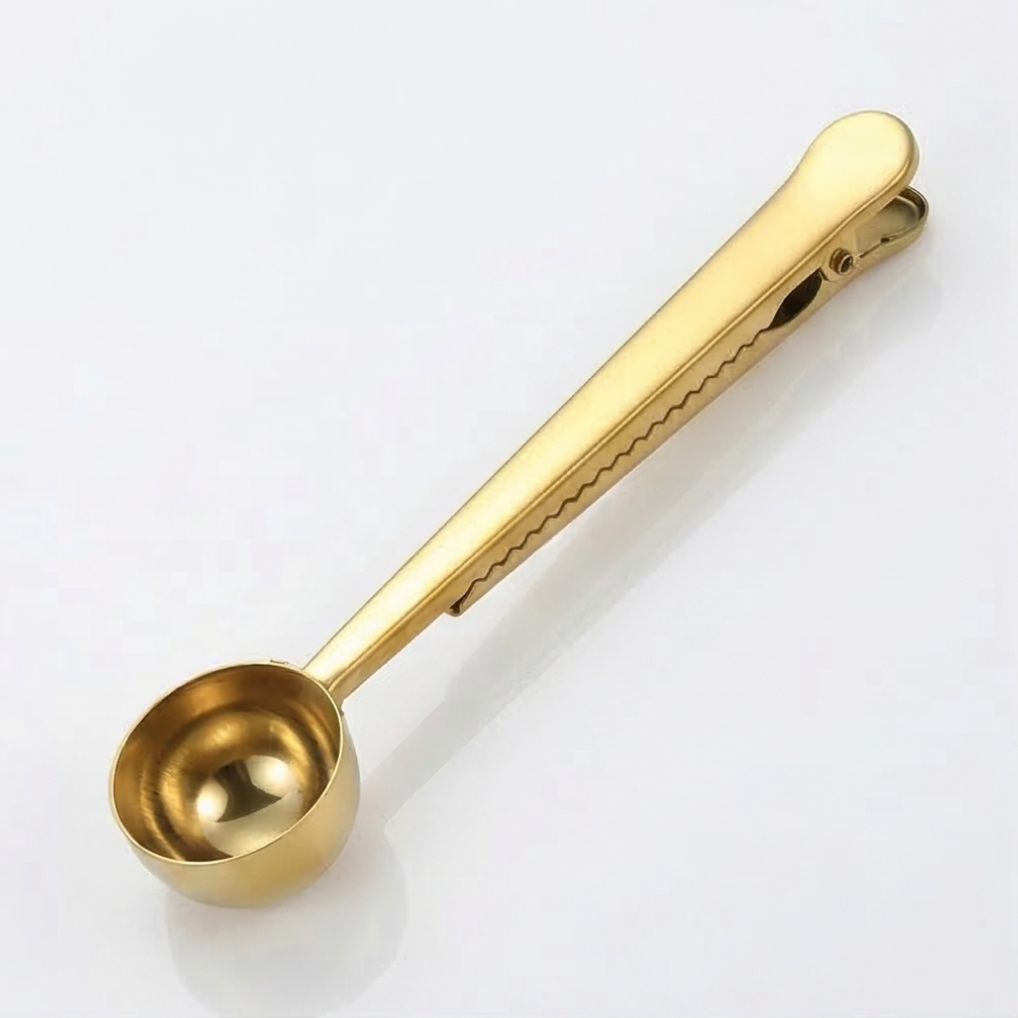 Gold metal measuring spoons on a white background.